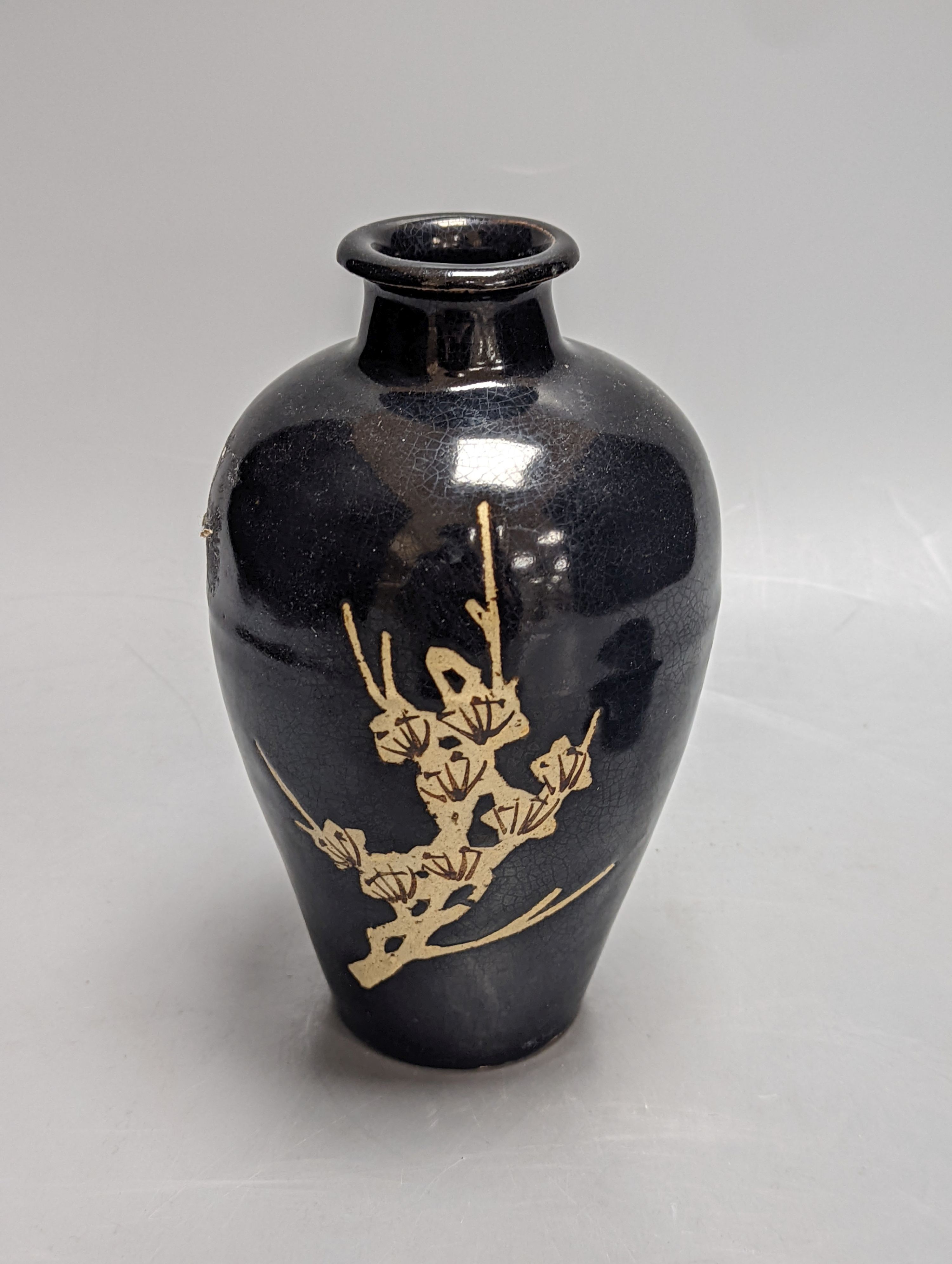 A Chinese oil spot glazed cup with integral stand and a black glazed resist pottery vase, 18cm